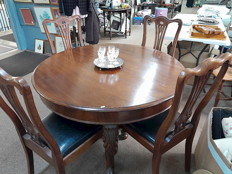 Round extending table with four chairs